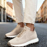Beige lace-up knit sneakers with rubber outsole and textured upper