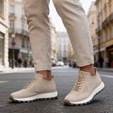 Beige knit sneakers, side view with lace-up closure and treaded sole