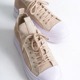 Men's beige knit low-top sneakers with white toe cap and lace-up front