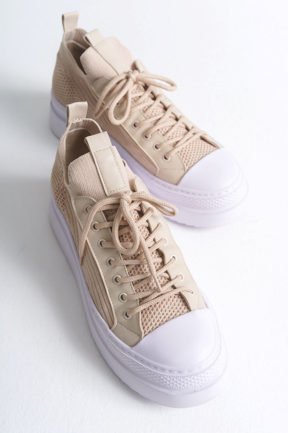 Men's beige knit low-top sneakers with white toe cap and lace-up front