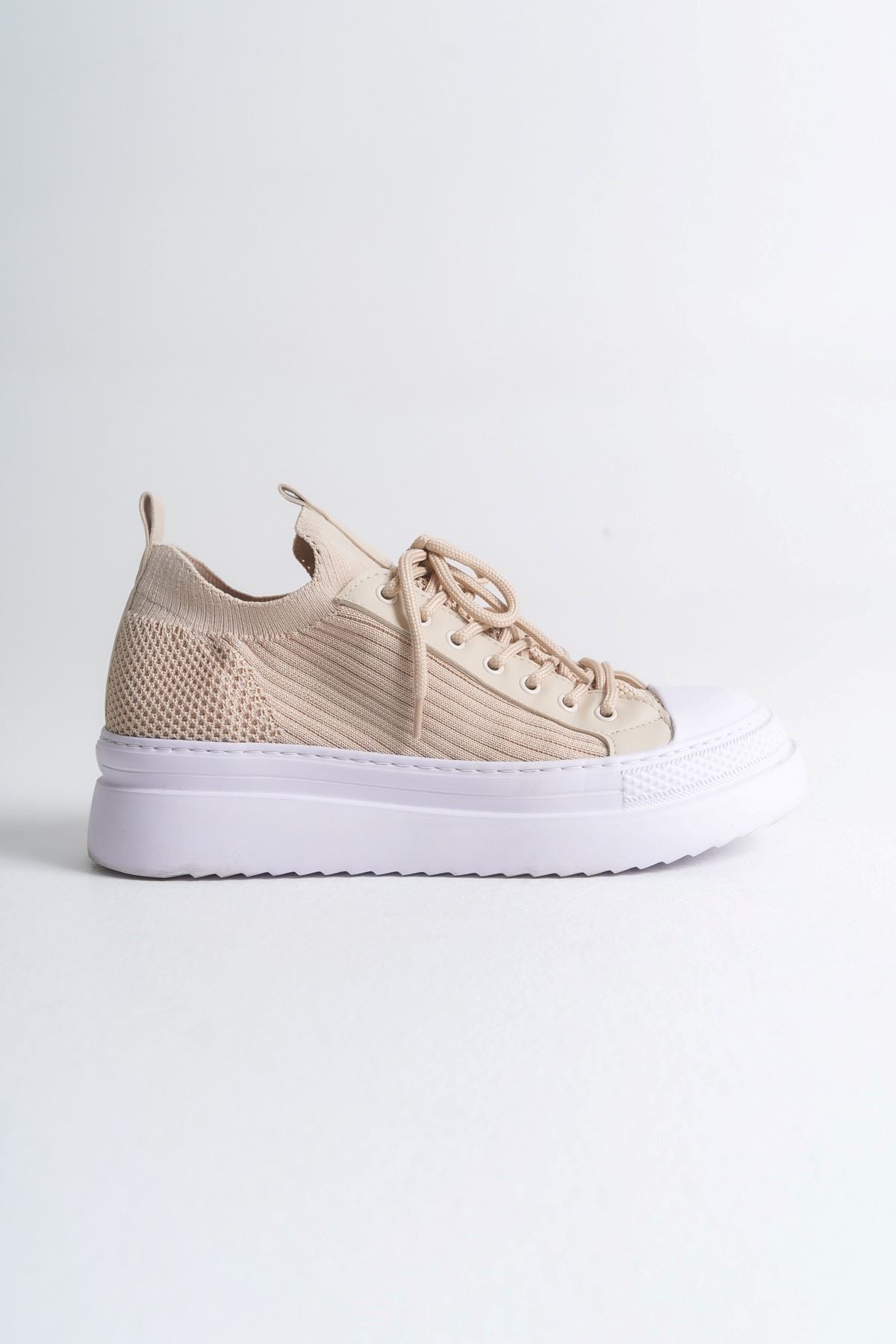 Men's beige knit sneaker with thick white sole and lace-up upper