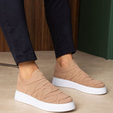 Beige knit slip-on sneakers with white rubber sole and wave stitch pattern