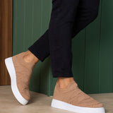 Beige knit sneakers with white rubber sole, low-profile slip-on design