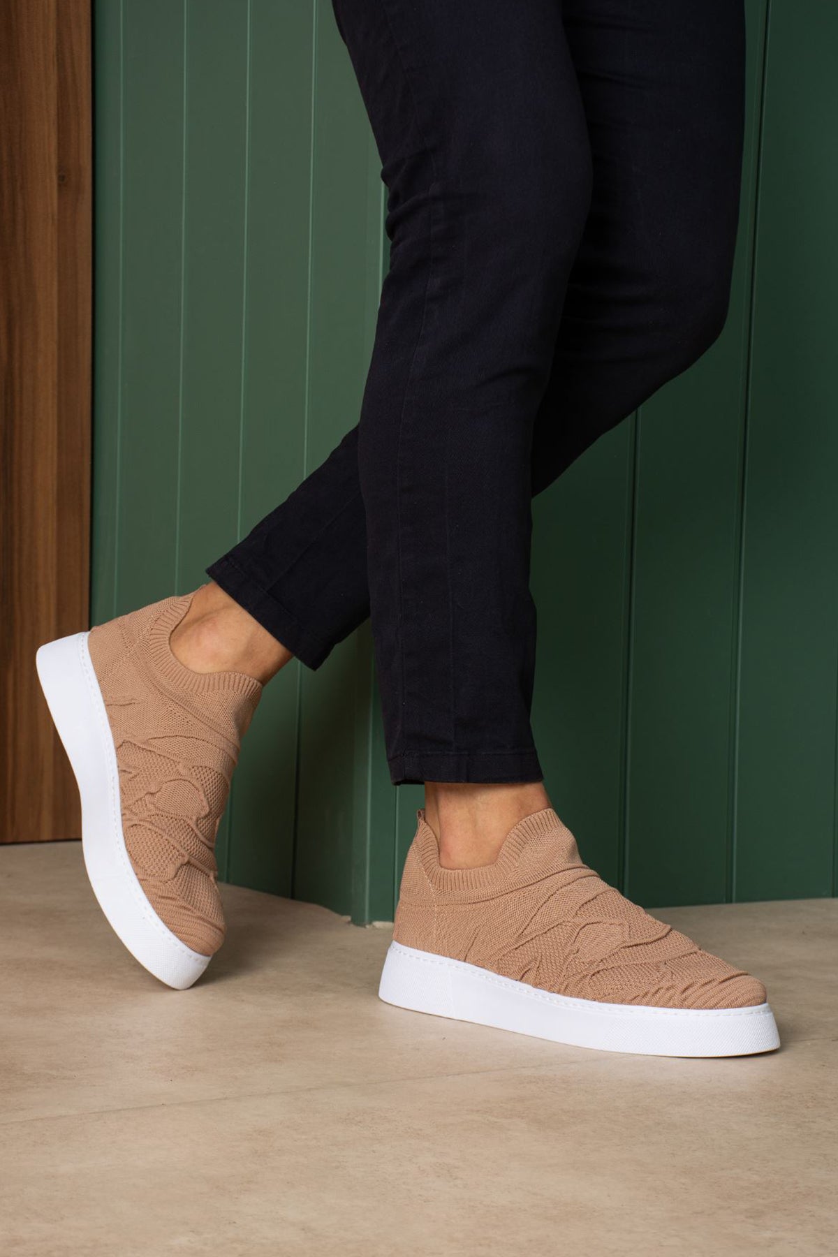 Beige knit sneakers with white rubber sole, low-profile slip-on design