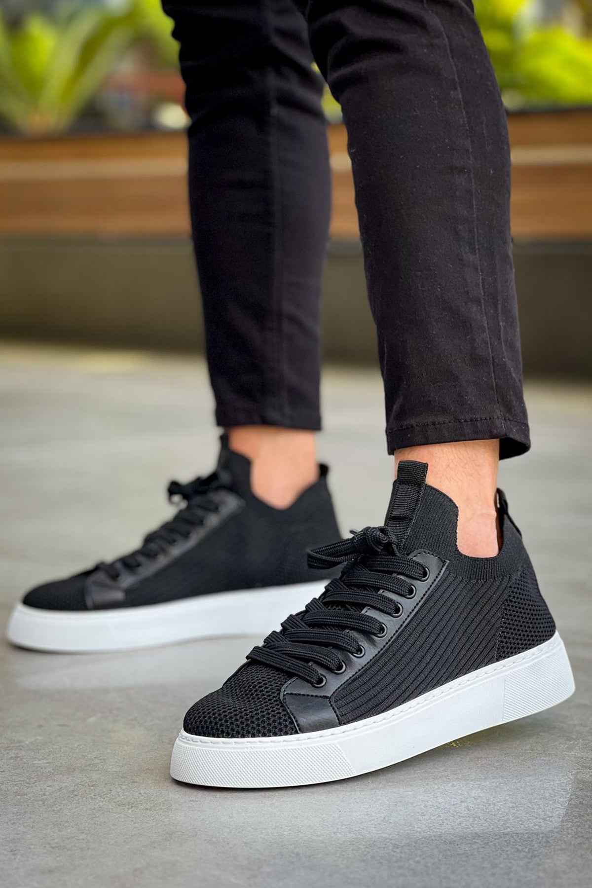 Men's black knit sneakers with lace-up eyelets and white rubber sole