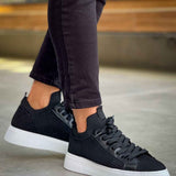Men's black knit sneakers, side view with lace-up closure and white cupsole