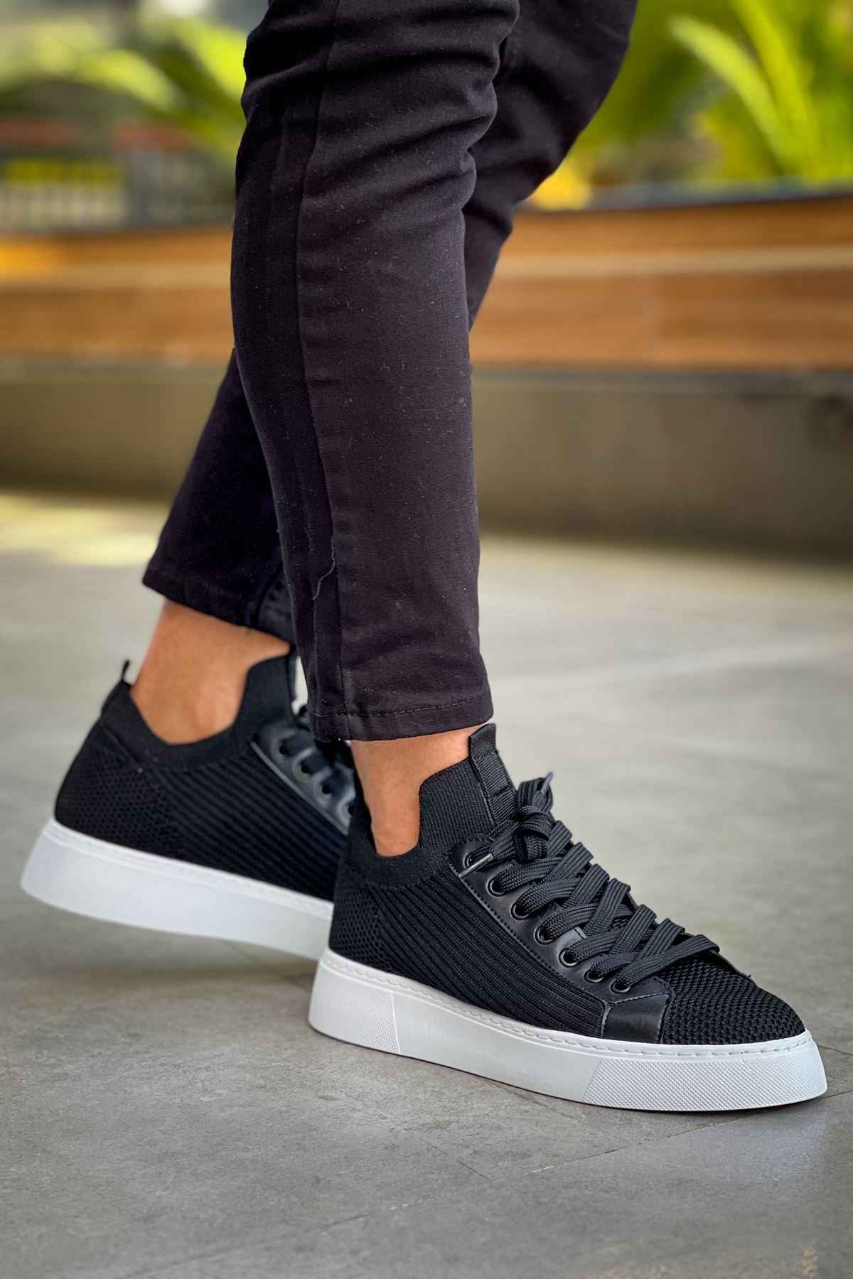 Men's black knit sneakers, side view with lace-up closure and white cupsole