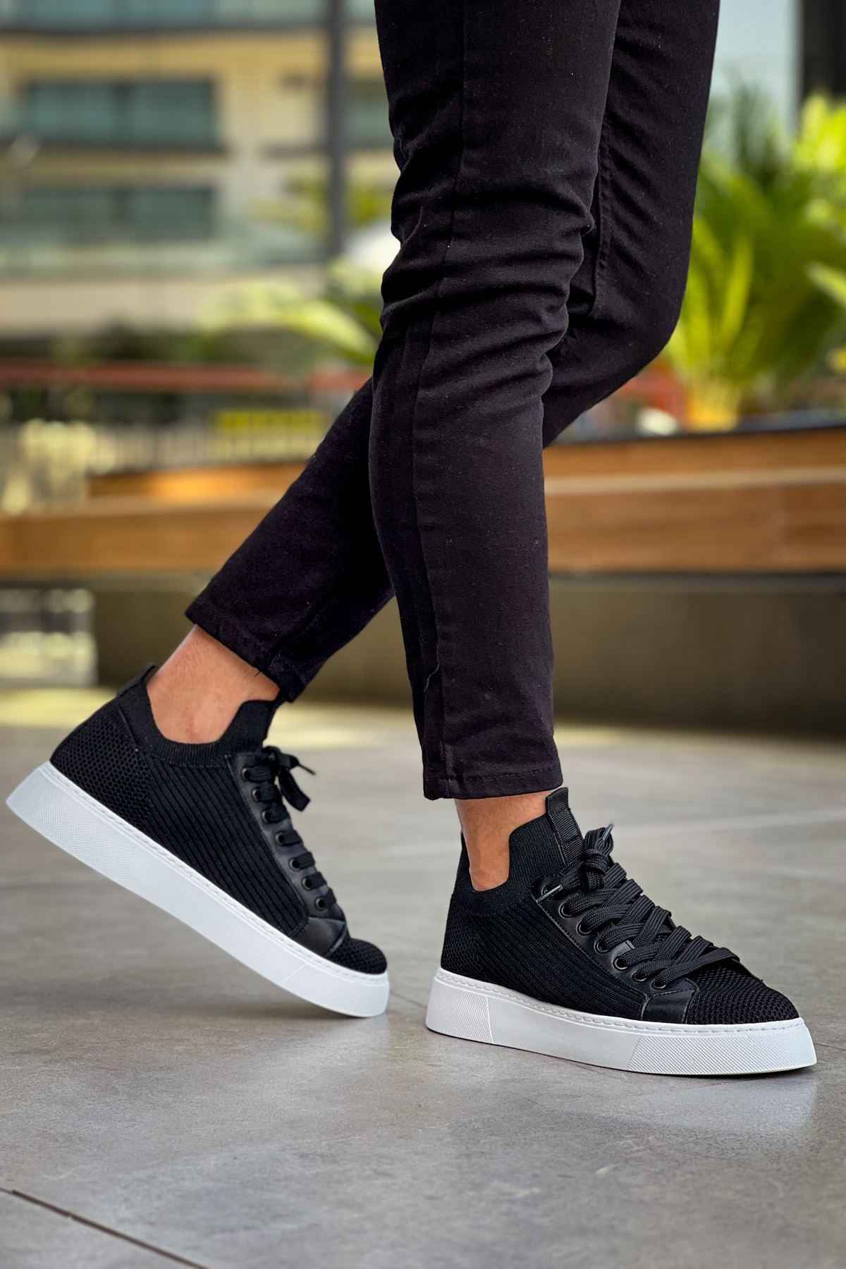 Men's black knit sneakers with low profile, lace-up design and white sole