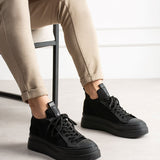 Black knit lace-up sneakers with low-profile rubber sole and padded heel