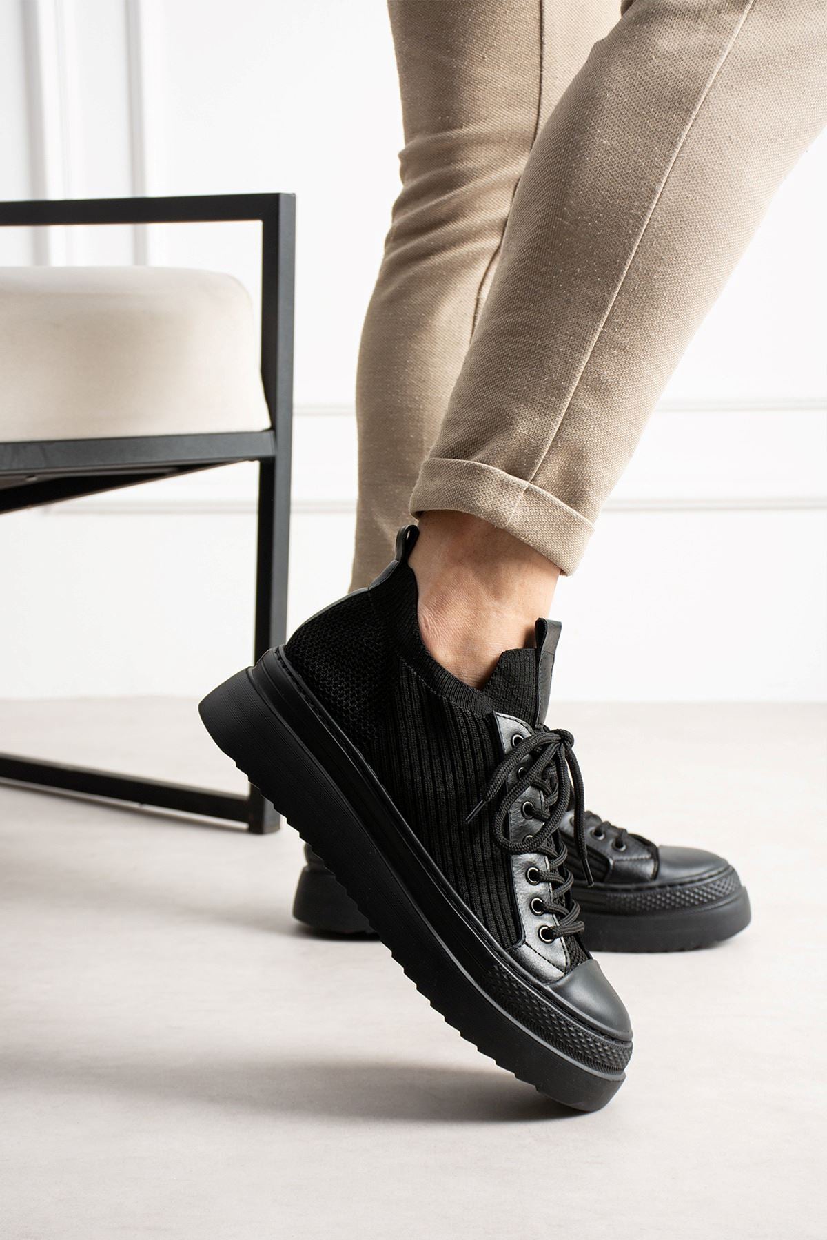 Black knit lace-up sneakers with side stripe detailing and chunky rubber outsole