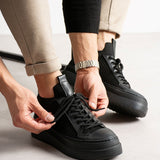Black knit lace-up sneakers with perforated toe and textured side panels