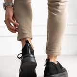 Black knit sneakers with rear pull tab, cushioned collar, and rubber heel