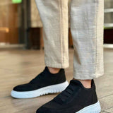 Men's black knit low-top sneakers with side strap detail and white rubber sole