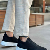 Men's black knit low-top sneakers with textured upper and white rubber sole
