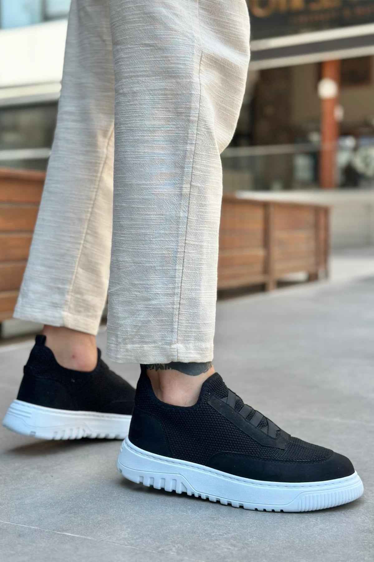 Men's black knit low-top sneakers with textured upper and white rubber sole