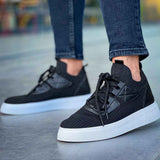 Low-top black knit sneakers with black laces and white sole, toe and side view