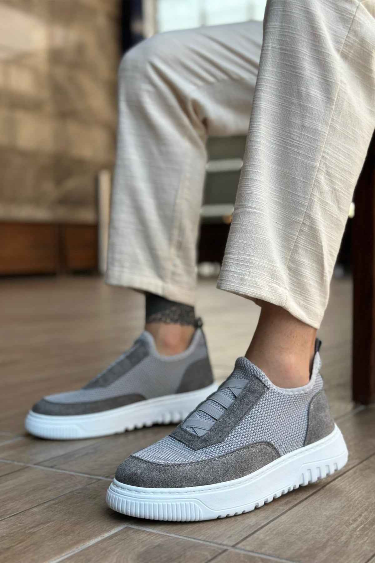 Gray knit slip-on sneakers with strap detail and white rubber sole