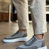 Gray knit sneakers, side view, strap detail and white rubber sole