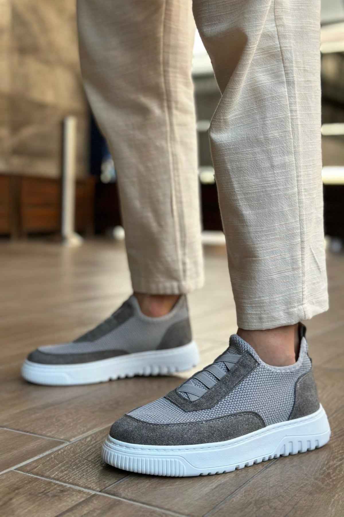 Gray knit sneakers, side view, strap detail and white rubber sole