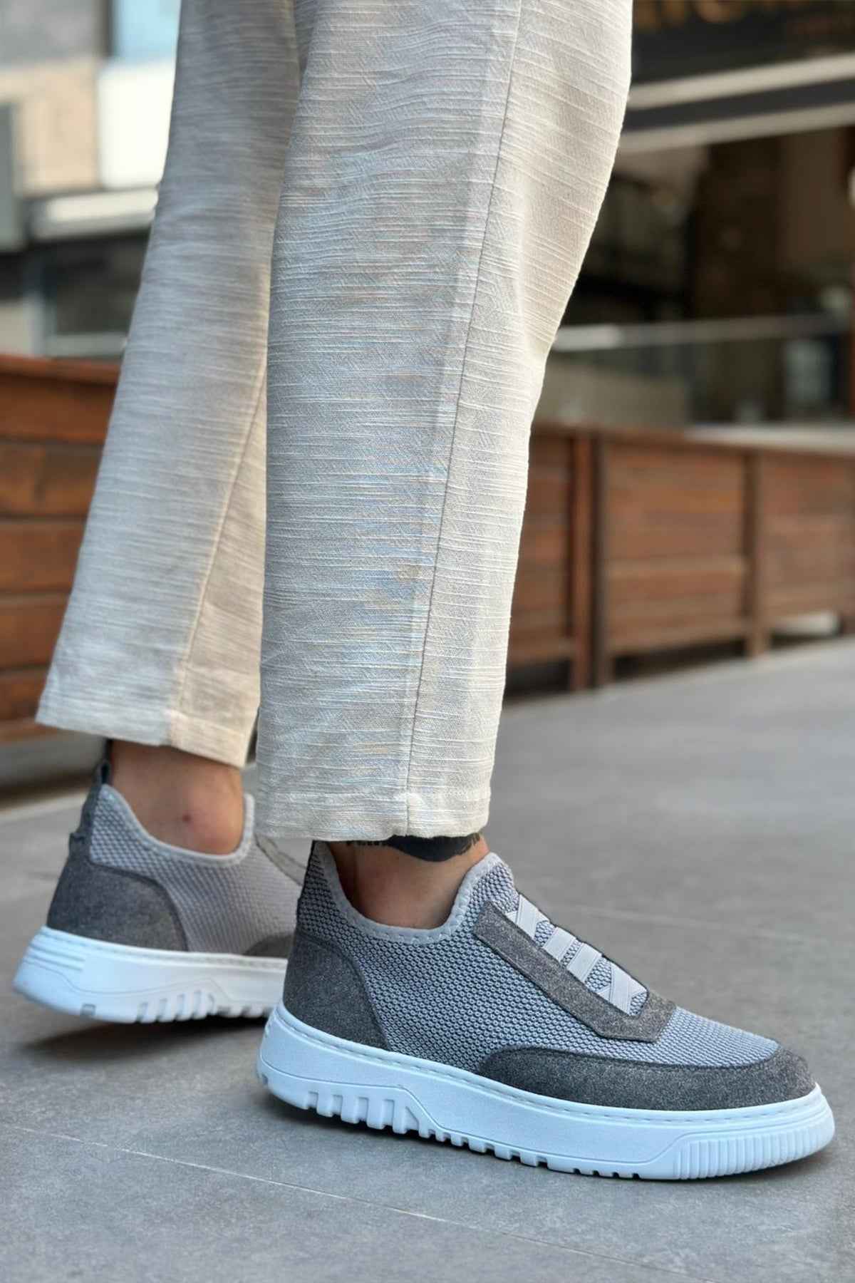 Gray knit sneakers with strap detail and low-profile white rubber sole