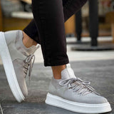Light gray knit sneakers with thick white sole, rear side view