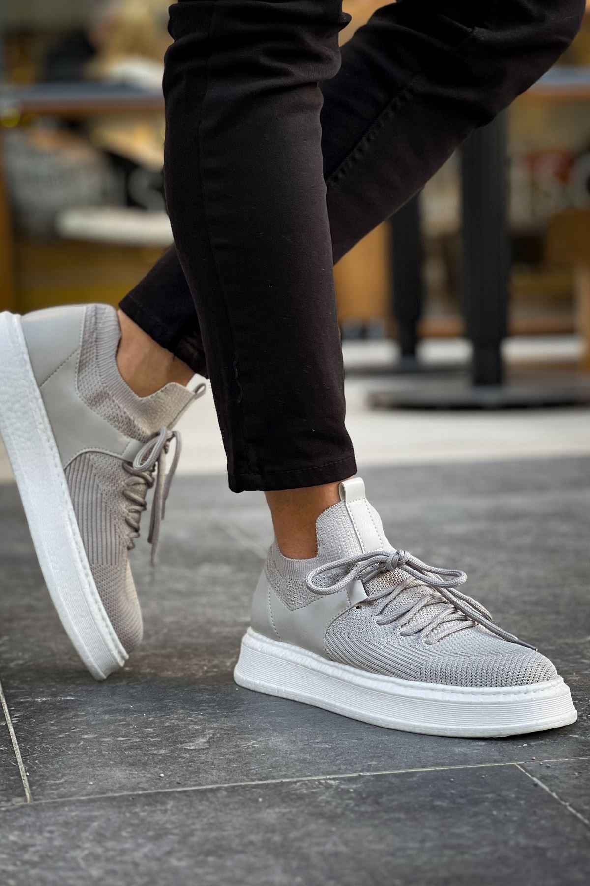 Light gray knit sneakers with thick white sole, rear side view