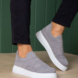 Gray knit slip-on sneakers with white rubber sole, side view