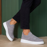 Gray knit slip-on sneakers with white sole, front three-quarter view