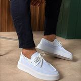 White and light blue lace-up knit sneakers, round toe, with white rubber sole.