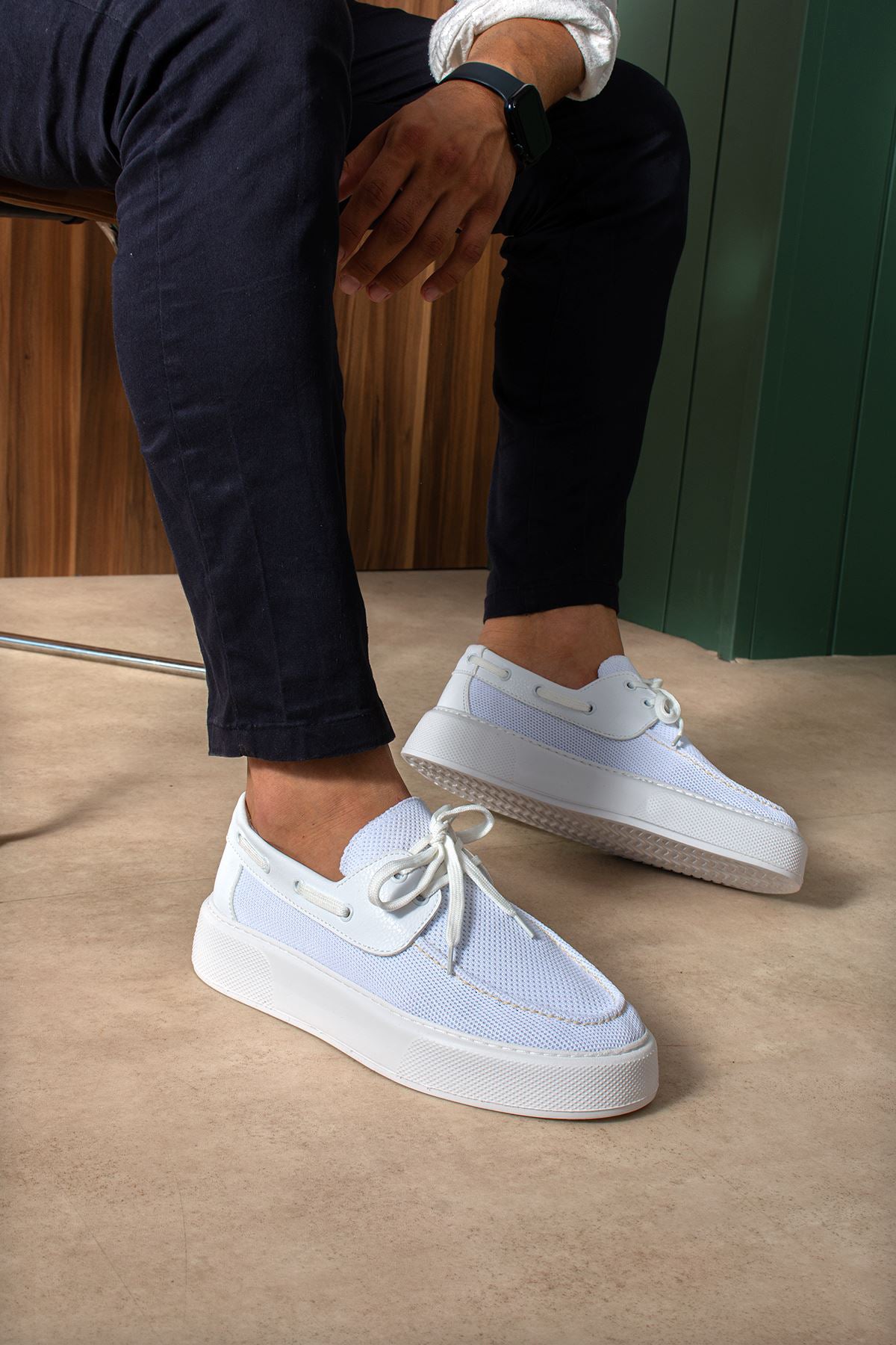 White and light blue lace-up knit sneakers, round toe, with white rubber sole.