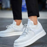 Men's knit white low-top sneakers with lace-up front and textured fabric