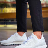White knit sneakers with lace-up front and chunky dark-tread sole