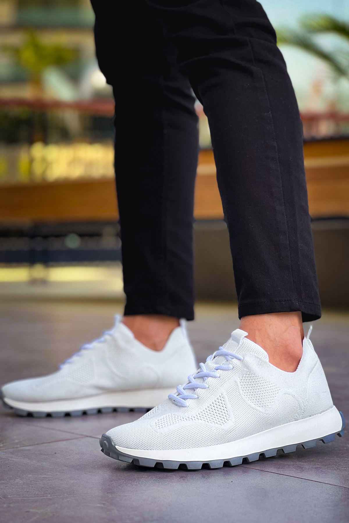 White knit sneakers with lace-up front and chunky dark-tread sole