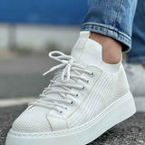 Men's knit white sneakers lace-up front with textured panels, close side view