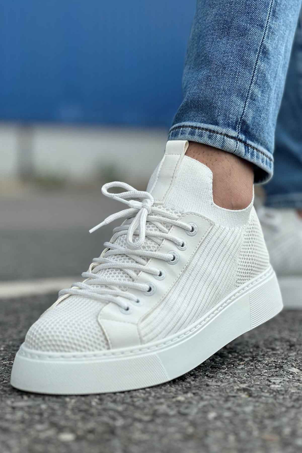 Men's knit white sneakers lace-up front with textured panels, close side view