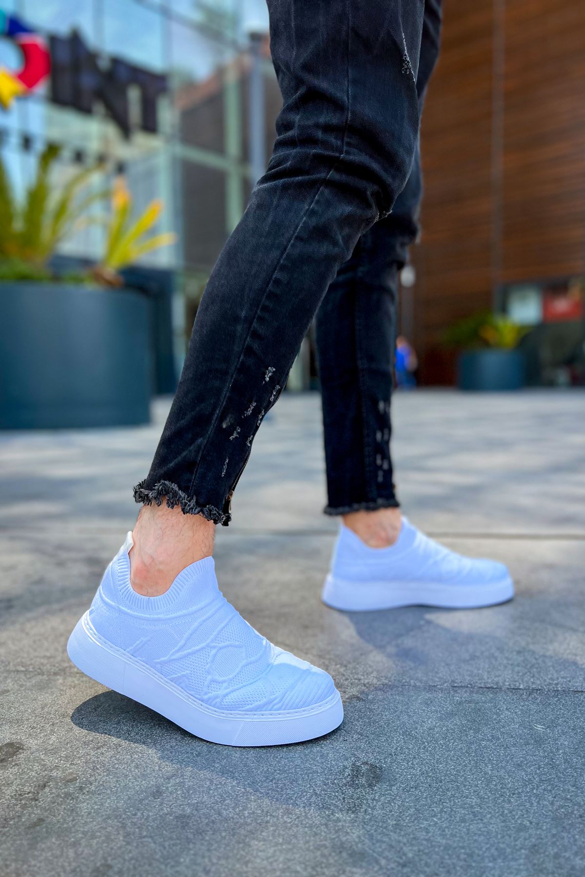 Men's white knit sneakers with round toe and thick sole, side view