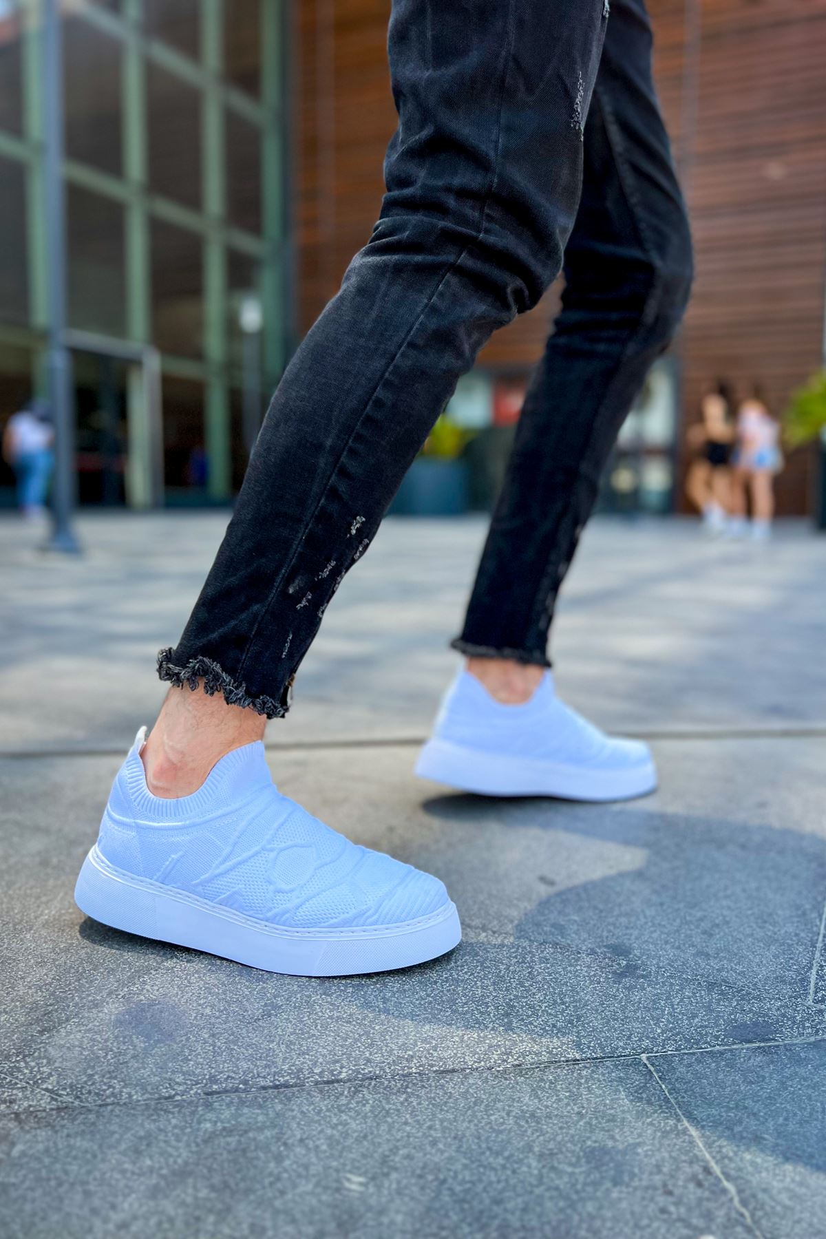 Men's white knit sneakers with elastic-like slip fit and clean low sole