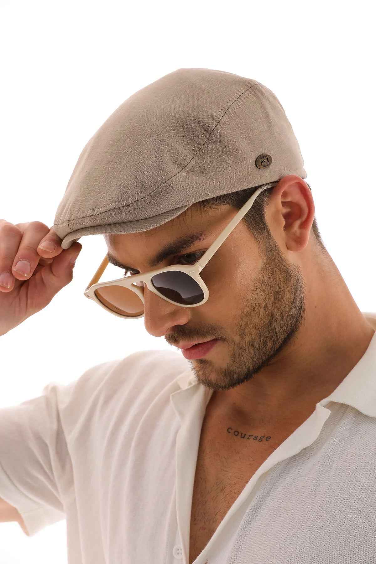 Men's mink flat cap Ritag in taupe, front side view with metal eyelet