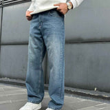 Relaxed blue denim jeans with wide straight legs and cuffed hems