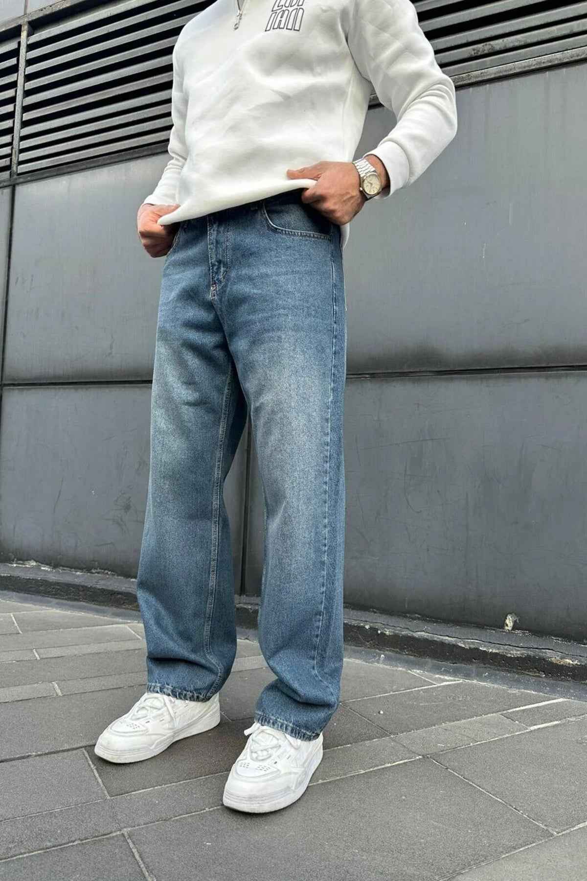 Relaxed blue denim jeans with wide straight legs and cuffed hems