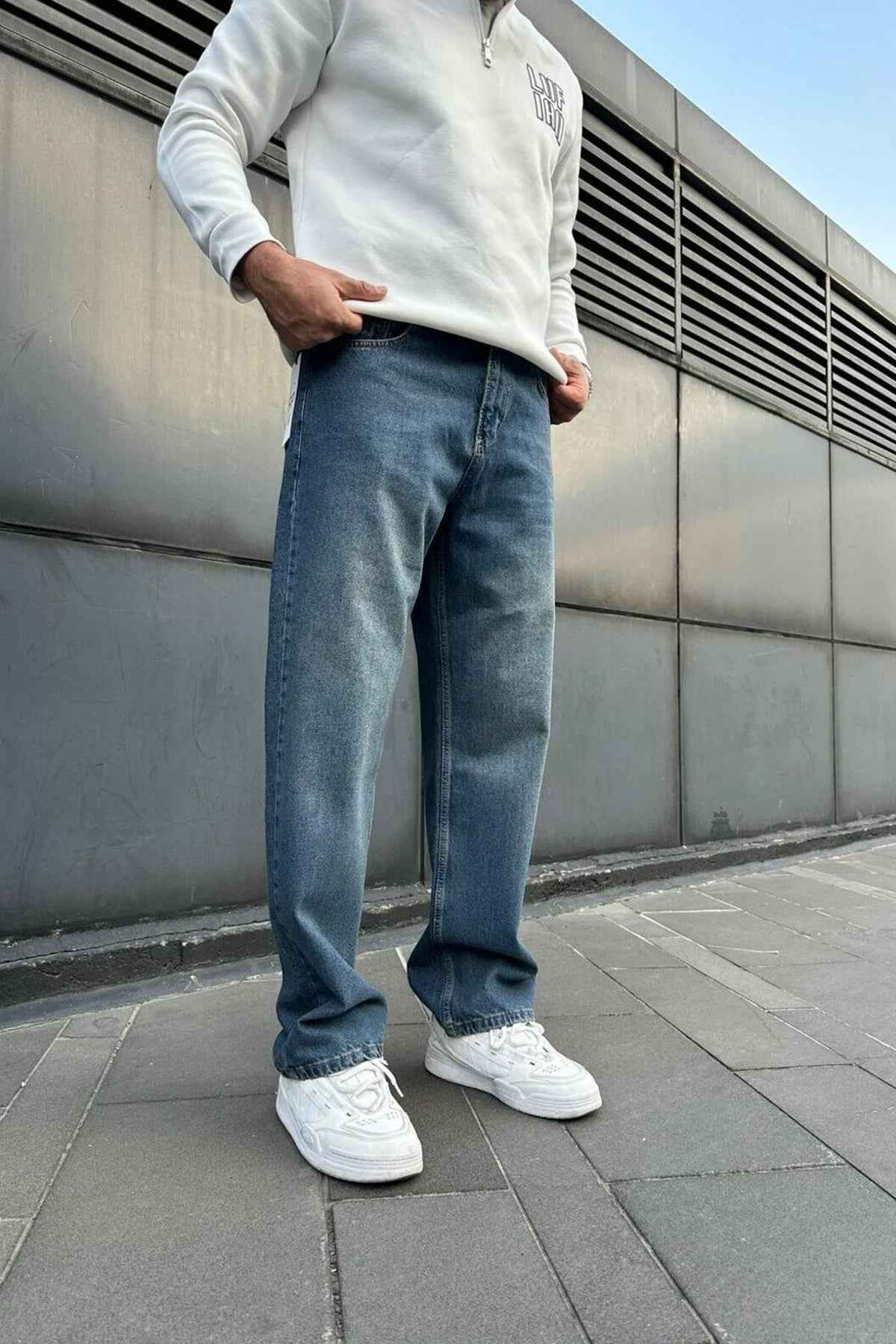 Men's navy baggy denim jeans with relaxed straight legs and side pockets