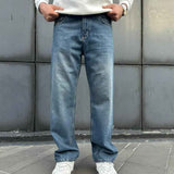 Relaxed-fit blue denim jeans front view, wide straight legs and cuffed hems