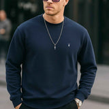 Men's navy crewneck sweatshirt with long sleeves and small chest logo