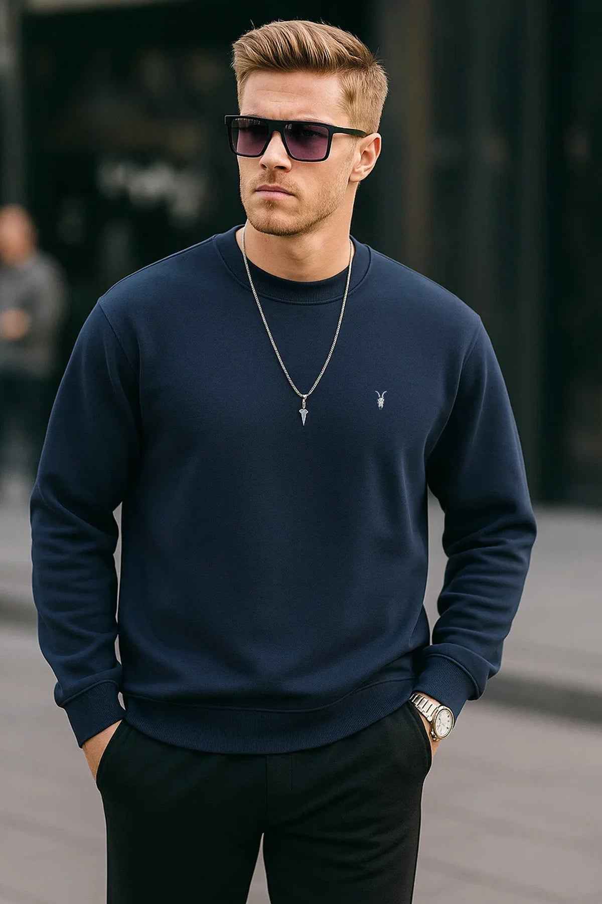 Men's navy crewneck sweatshirt with long sleeves and small chest logo