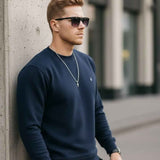 Men's navy crewneck sweatshirt with long sleeves and ribbed cuffs