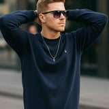 Men's navy crewneck sweatshirt with ribbed neckline, cuffs, and hem
