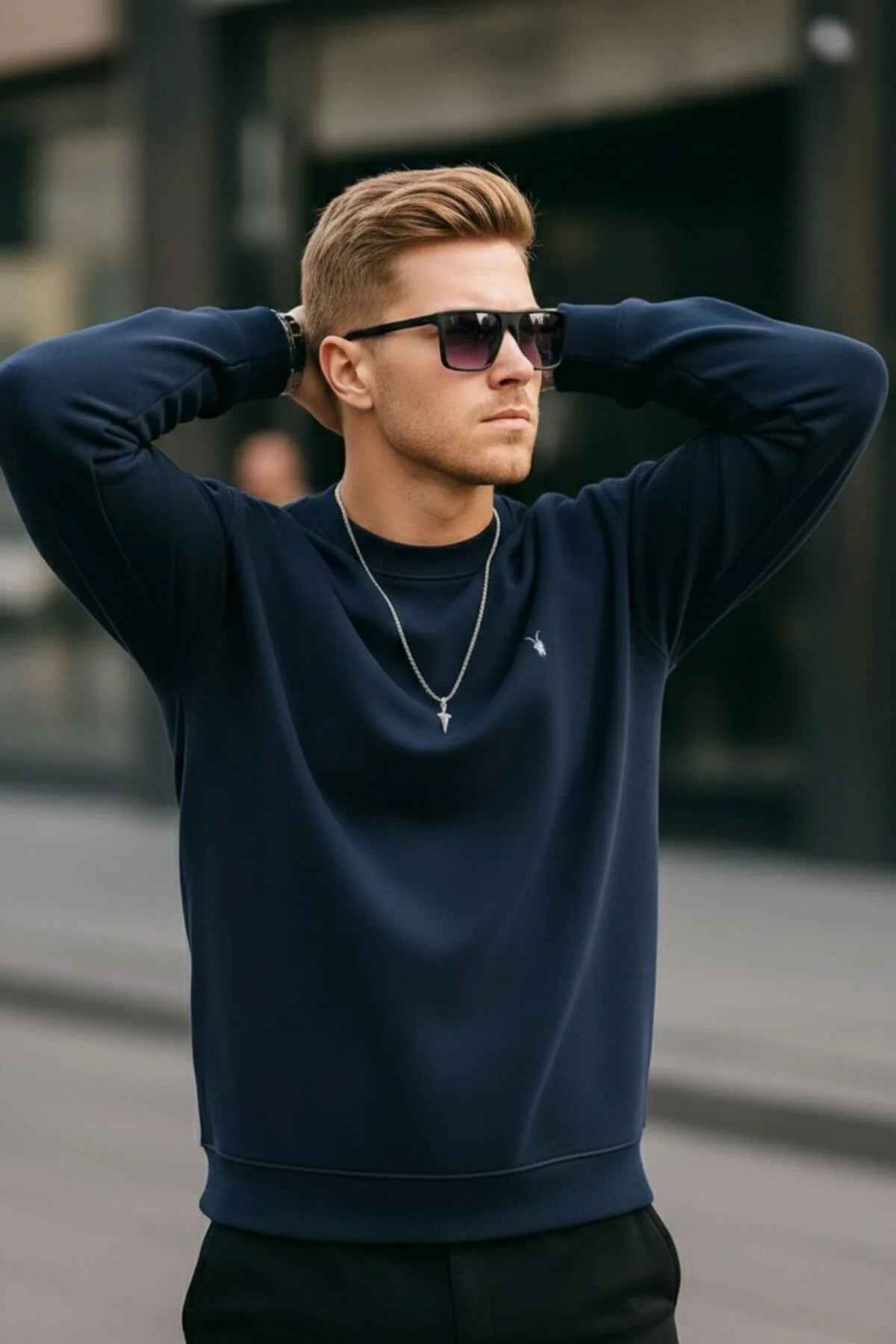 Men's navy crewneck sweatshirt with ribbed neckline, cuffs, and hem