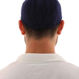 Men's navy blue flat cap back view, rounded crown and curved brim