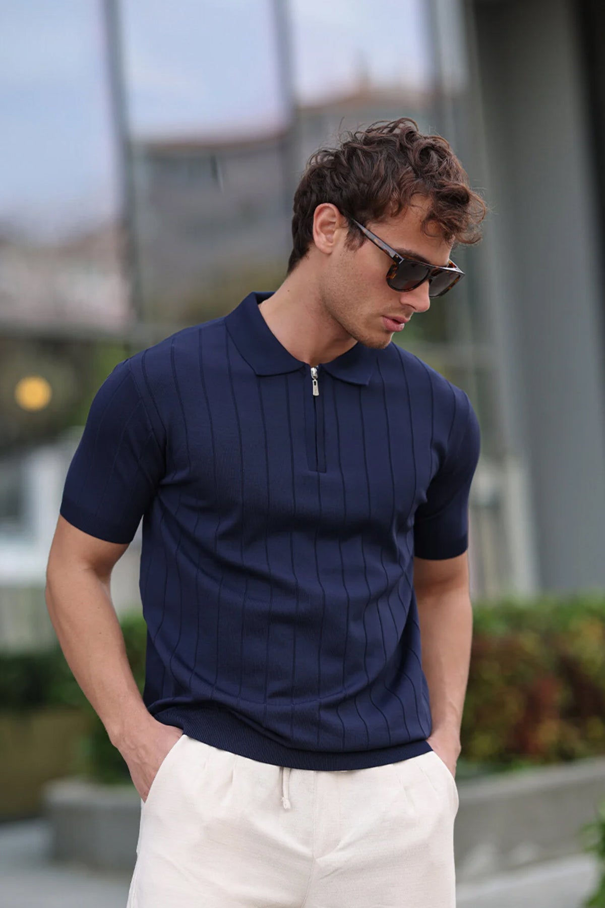 Men's navy knit half-zip polo shirt, short sleeves, ribbed collar, vertical stripes