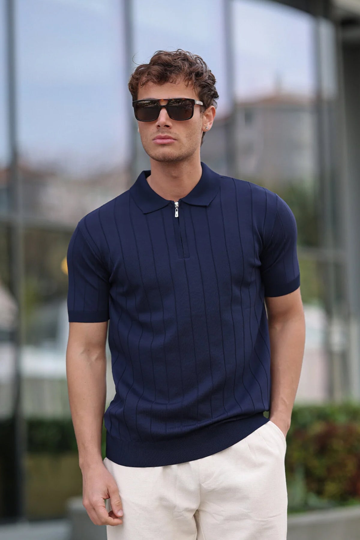 Men's navy half-zip knit polo shirt with short sleeves and zip-front placket